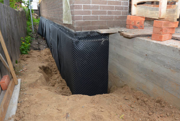 Happy homeowners after waterproofing job in New Weston